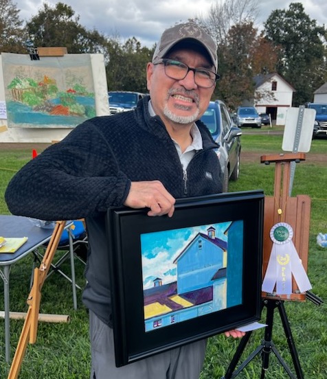 Me holding my third place painting titled "Building Blocks 2"