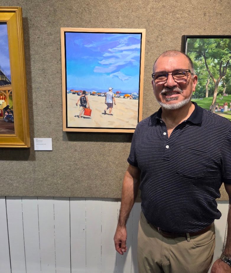 Francisco Silva at SCNY in front of his painting "Wandering the Wasteland".